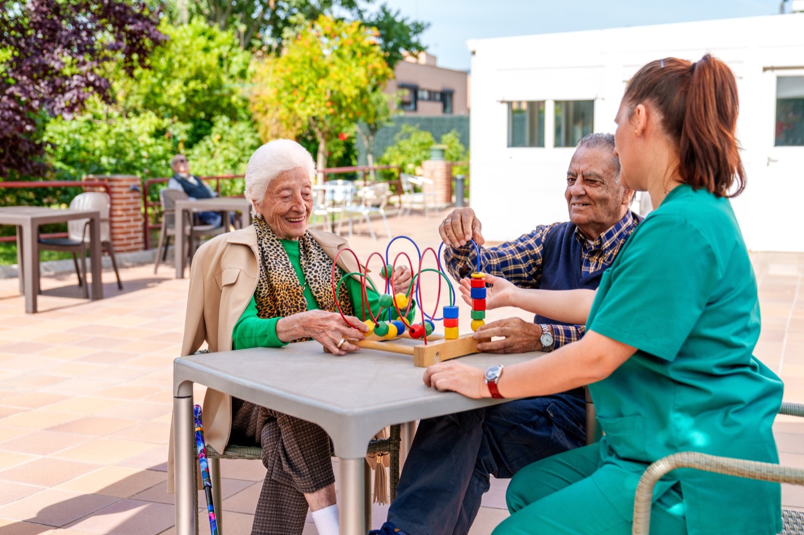 Caregiver sharing an activity with residents